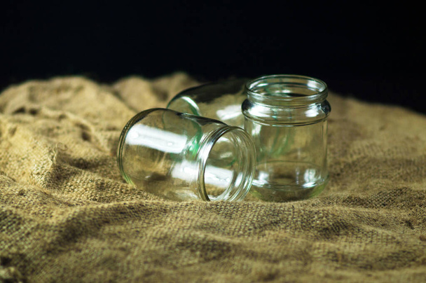 glass jars on a black background for storing food for the winter - Photo, Image