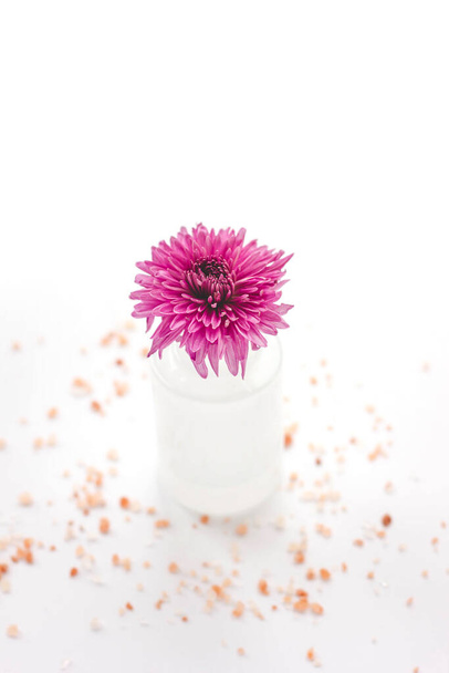 Aromatic pink flower in a perfume bottle. Isolated white background - Φωτογραφία, εικόνα
