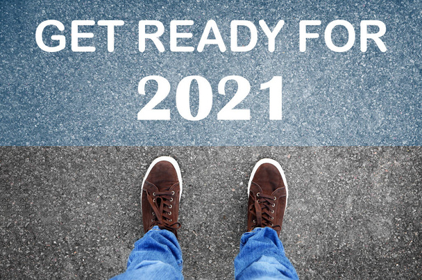Text Get Ready For 2021 on asphalt in front of man, top view - Foto, afbeelding