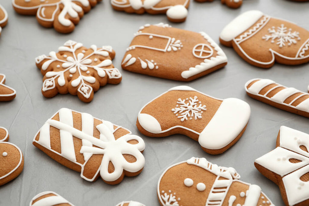 Different Christmas gingerbread cookies on grey background, closeup - Photo, image