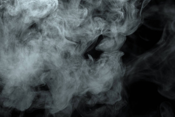 Abstract powder or smoke effect isolated on black background - Фото, изображение