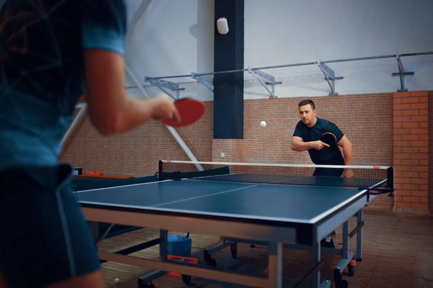 Two men play table tennis, ping pong players - Photo, image
