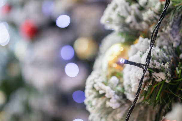 Decorated Christmas light on fir tree New Year holidays background - Fotografie, Obrázek