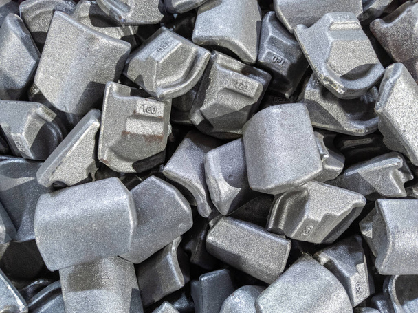 heap of gray steel forgings after shot blasting - close-up natural heavy industrial pattern with selective focus - Photo, Image