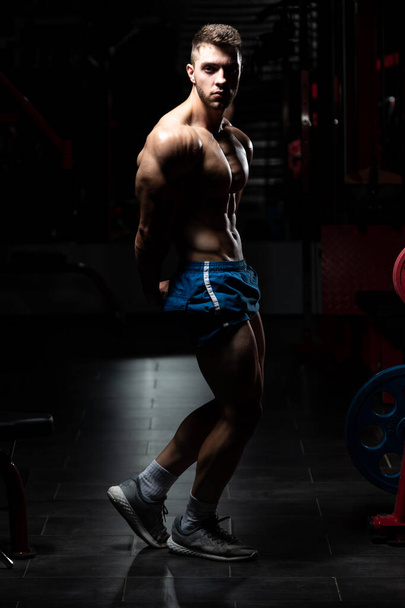 Portrait Of A Young Physically Fit Man Showing His Well Trained Body - Muscular Athletic Bodybuilder Fitness Model Posing After Exercises - Photo, image