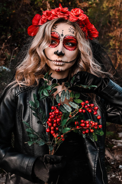 Retrato de cerca de Calavera Catrina. Mujer joven con maquillaje de cráneo de azúcar y flores rojas. Día de los muertos. Día de los Muertos. Halloween. - Foto, Imagen