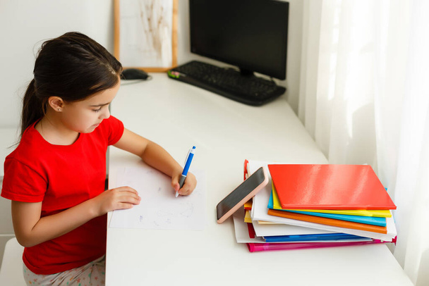 Distance learning online education, little girl writes formulas - Foto, Imagem