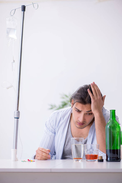 Young man in alcohol addiction treatment concept - Photo, Image