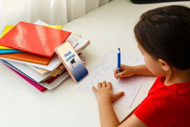 Distance learning online education, little girl writes formulas - Photo, Image