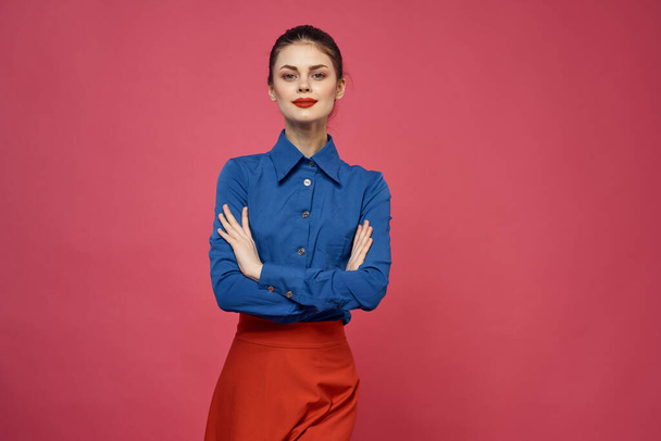 Woman in blue shirt and red cubes on pink background fun emotions model cropped view - 写真・画像