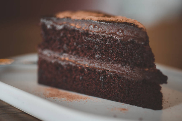 Chocolate fudge cake sliced in cafe. Selective focus - Foto, afbeelding