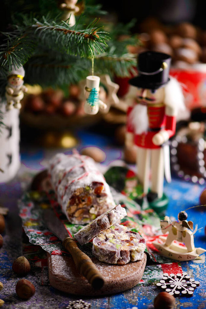 Christmas chocolate salami on a Christmas rustic background. Style rustic . selective focus - Photo, Image