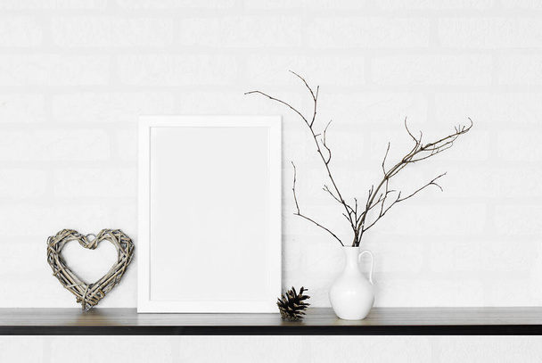 empty frame and vase of dry flowers in white wall - Photo, Image