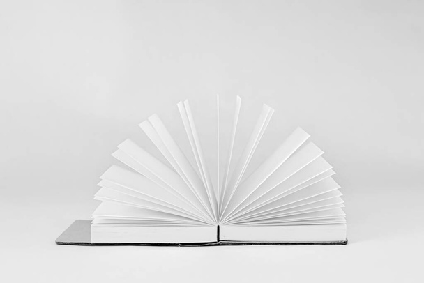 Fan unfold open small notepad with blank light pages. Notebook. White background.  - Фото, зображення