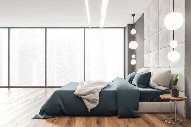 Вид на современную спальню с белыми и темными стенами, деревянным полом и удобной двуспальной кроватью с синим одеялом. 3d-рендеринг - Фото, изображение