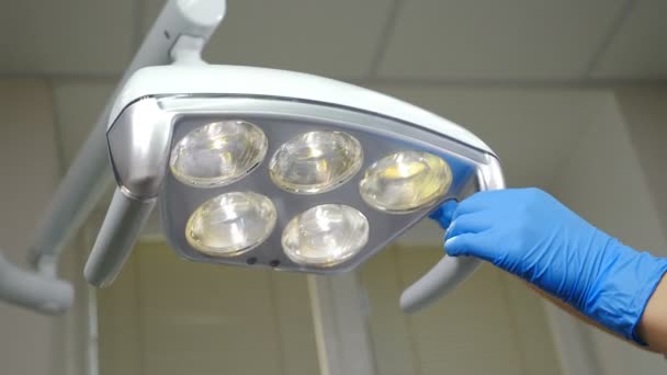 Cleaning medical lamp in dental clinic, operating medical facility in cabinet. Clinic Hygiene Concept. Sterilization and disinfection, Preparing dental cabinet office before treating patient. 4 k - Footage, Video