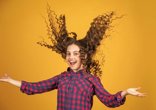Strong and healthy hair concept. Small child long hair. kidding around. happy girl with long windy hair. healthy and strong hair. good shampoo or lotion. hairdresser beauty salon - Valokuva, kuva