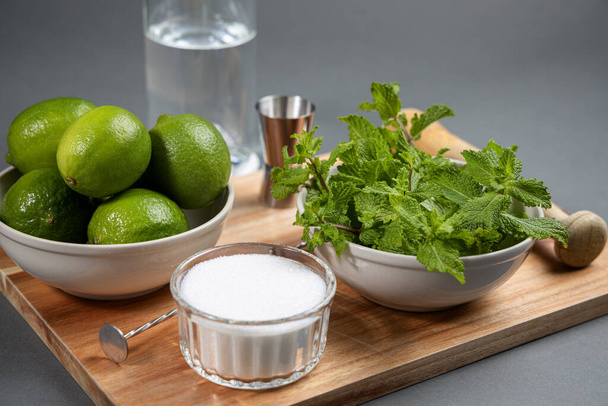 Mojito cocktail ingredients and tools on wooden cutting board - Photo, Image