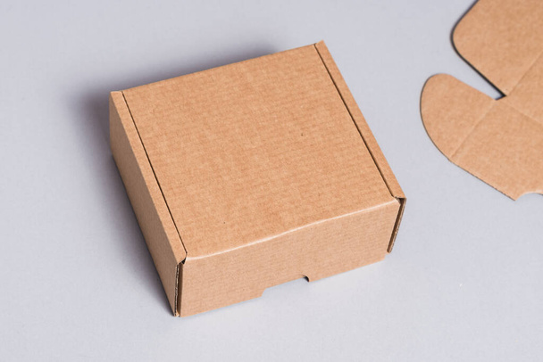 Brown cardboard box on grey background  - 写真・画像