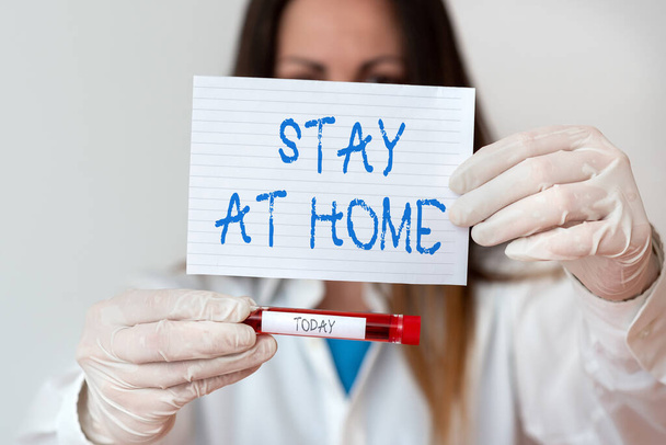 Text sign showing Stay At Home. Conceptual photo movement control restricting individuals from getting exposed publicly Laboratory blood test sample shown for medical diagnostic analysis result. - Foto, Bild