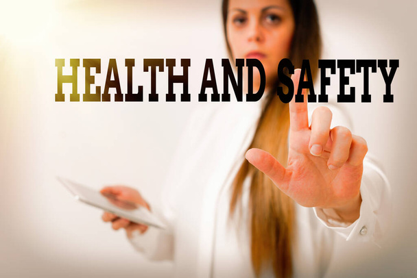 Text sign showing Health And Safety. Conceptual photo procedures intended to prevent accident in workplace Model with pointing hand finger symbolizing navigation progress growth. - Photo, Image
