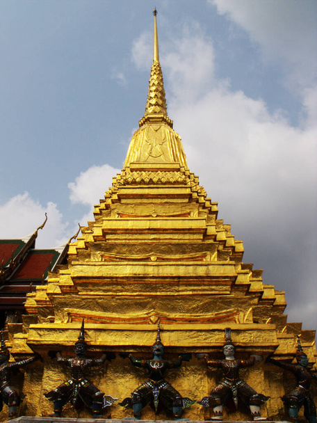 Бангкок, Таиланд, 25 января 2013 года: Золотая ступа, удерживаемая скульптурами воинов в Королевском дворце в Бангкоке - Фото, изображение