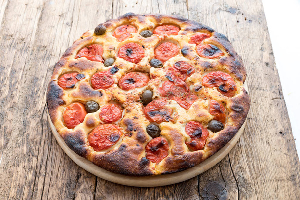 Focaccia typical of Bari Italy with tomatoes and olive - Photo, Image