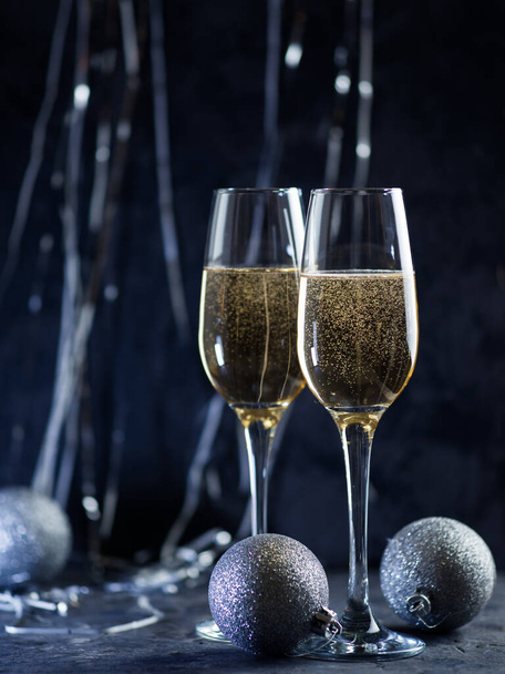 Merry Christmas and happy new year! Two glasses of champagne on holiday background - Photo, Image