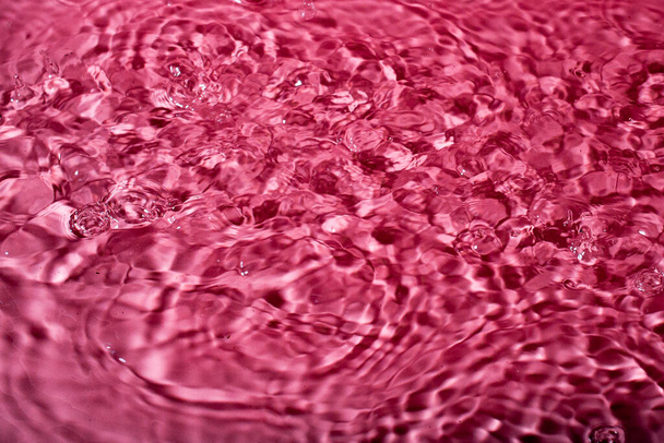 splash of water on a red background. Abstract wallpaper - Foto, Imagem