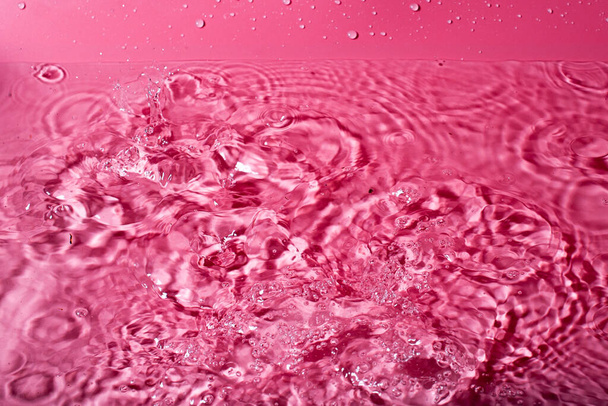 splash of water on a red background. Abstract wallpaper - Valokuva, kuva