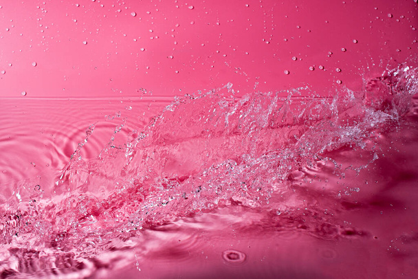 splash of water on a red background. Abstract wallpaper - Фото, изображение