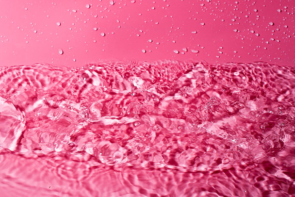splash of water on a red background. Abstract wallpaper - Foto, immagini