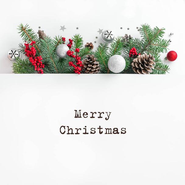 Christmas composition. Christmas tree branches and pine cones on multilayer white background. Top view, copy space. - Foto, afbeelding