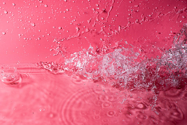 splash of water on a red background. Abstract wallpaper - Φωτογραφία, εικόνα