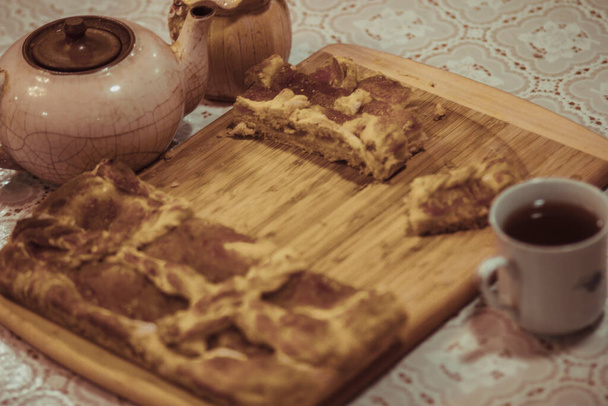 Festive flavored Russian traditional pie with Apple jam and a Cup of tea - 写真・画像