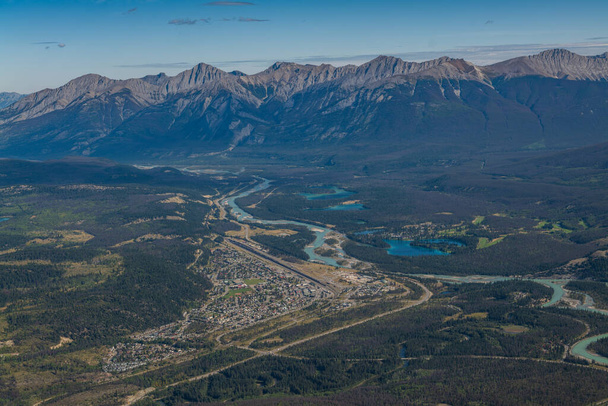 Town of Jasper Alberta, Canada from an aerial view and mountains and lakes in the distance - Foto, Bild