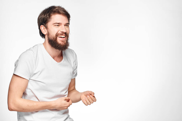 cheerful emotional bearded man gesturing with his hands close-up light background - Photo, image