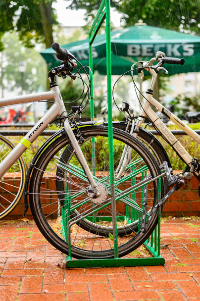 Berlin, Almanya - 13 Temmuz 2019: Berlin, Almanya 'da yağmurlu bir günde bisikletler park edildi. - Fotoğraf, Görsel