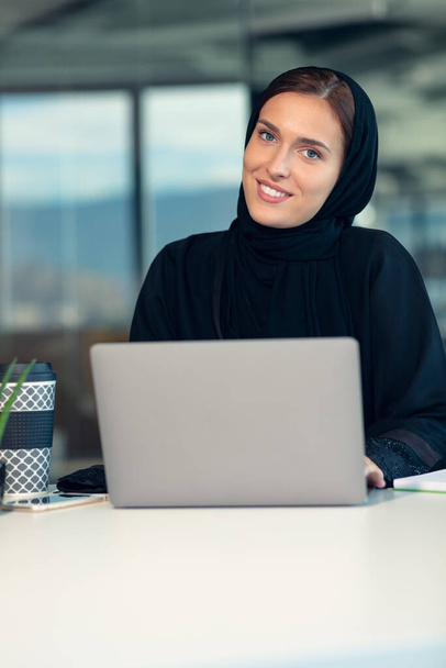 Pensive arabic businesswoman sitting at workplace in office - Фото, зображення