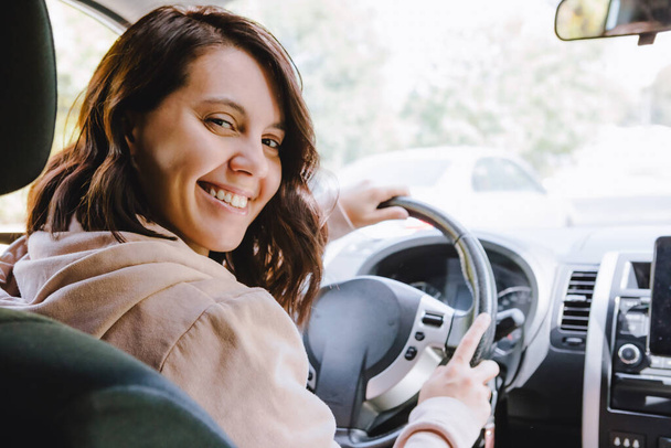 jovem mulher motorista bonita sentado na vista do carro a partir de dentro - Foto, Imagem