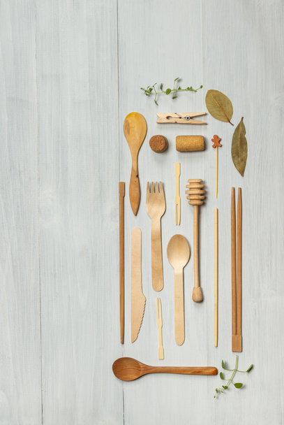Flat lay of eco-friendly recyclable wooden Cutlery and accessories. Top view on a light wooden background with space - Photo, image