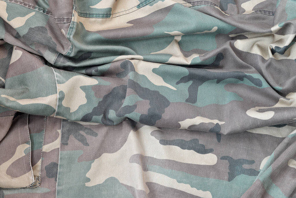 Camouflage background texture as backdrop for russian or ussr snipers design projects. Back side of snipers camouflage jacket with many pleats on crumpled fabric - Photo, Image