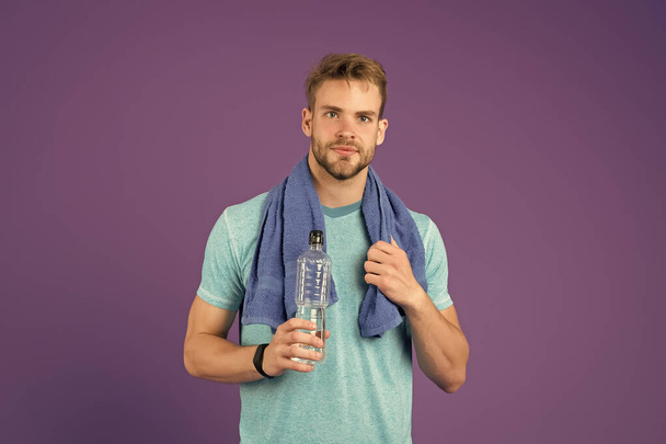 Man athletic hold water bottle. Handsome athlete drink water. Water balance. Sport for better life. Thirsty man. Athlete hold bottle. Body hydration. Refreshing vitamin drink after great workout - Fotó, kép