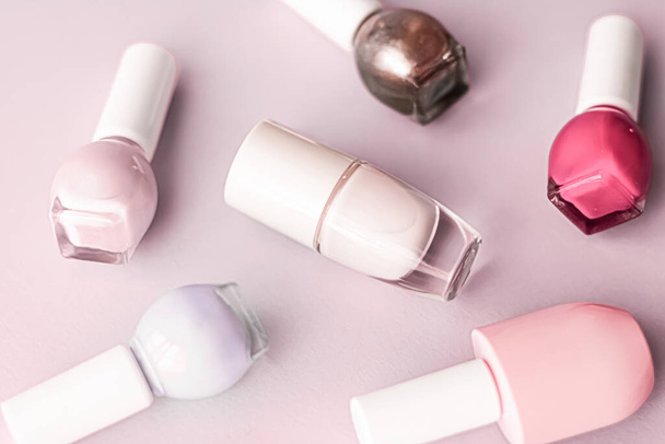 Nail polish bottles on blush pink background, beauty brand - Photo, Image
