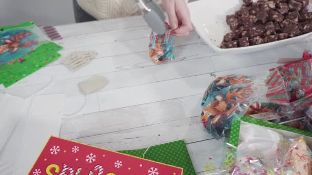 Βήμα-βήμα. Συσκευασία σπιτική fudge και μπισκότα σε ένα χριστουγεννιάτικο κουτί δώρου. - Πλάνα, βίντεο
