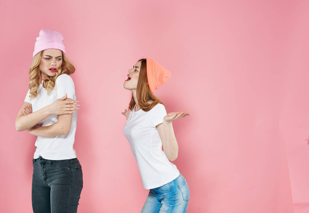 Two girlfriends fashionable clothes fun and joy lifestyle pink background - Φωτογραφία, εικόνα