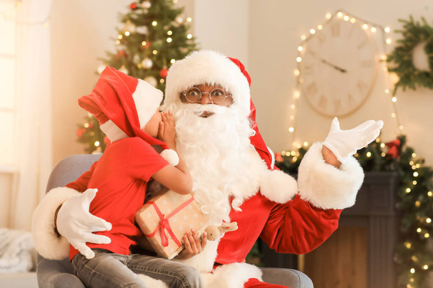 African-American boy telling Santa Claus his wish at home on Christmas eve - Photo, Image