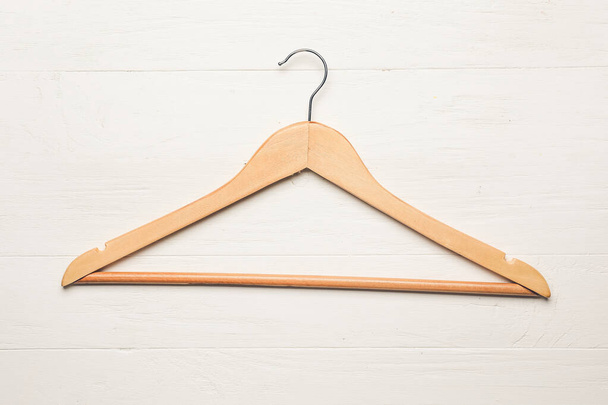 Clothes hanger on wooden  background - Foto, afbeelding