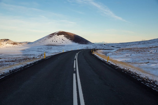 A beautiful shot of a highway in a snowy mountain landscape in Snaefellsnes, Iceland - Zdjęcie, obraz