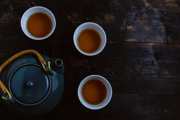 A top view of a gray tea set on dark wooden background - Zdjęcie, obraz